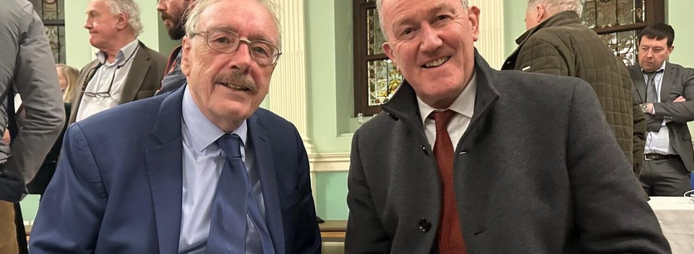 Ray Bassett signing a copy of his book for senator Conor Murphy