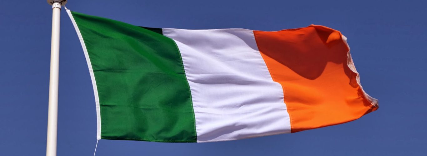 The Irish tricolour flag and blue sky.